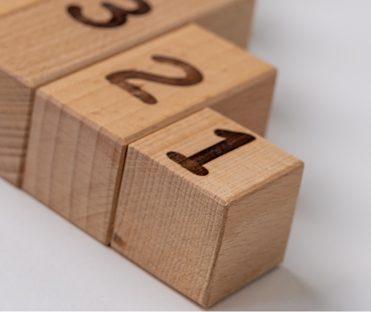 Close up of Montessori wooden number blocks showcasing trimmed edges and number engravings