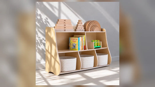 Montessori toy shelf by Dannico Woodworks with books, toys, and storage baskets in a bright playroom