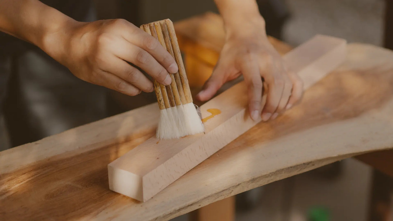 A man brushing on wood finisher