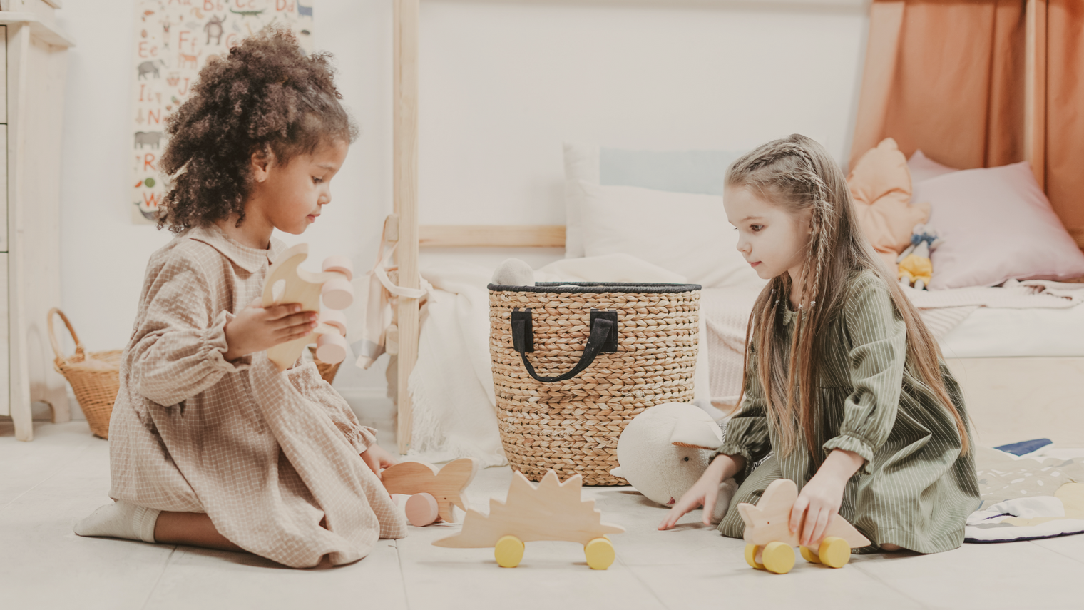 Two children playing with wooden toys using Montessori methods.