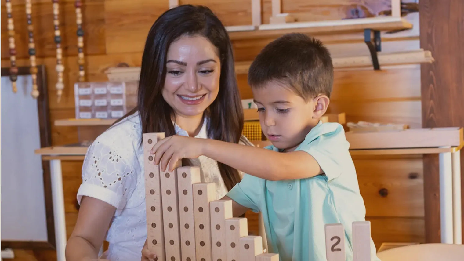 Adult and child playing Montessori games with wooden number blocks