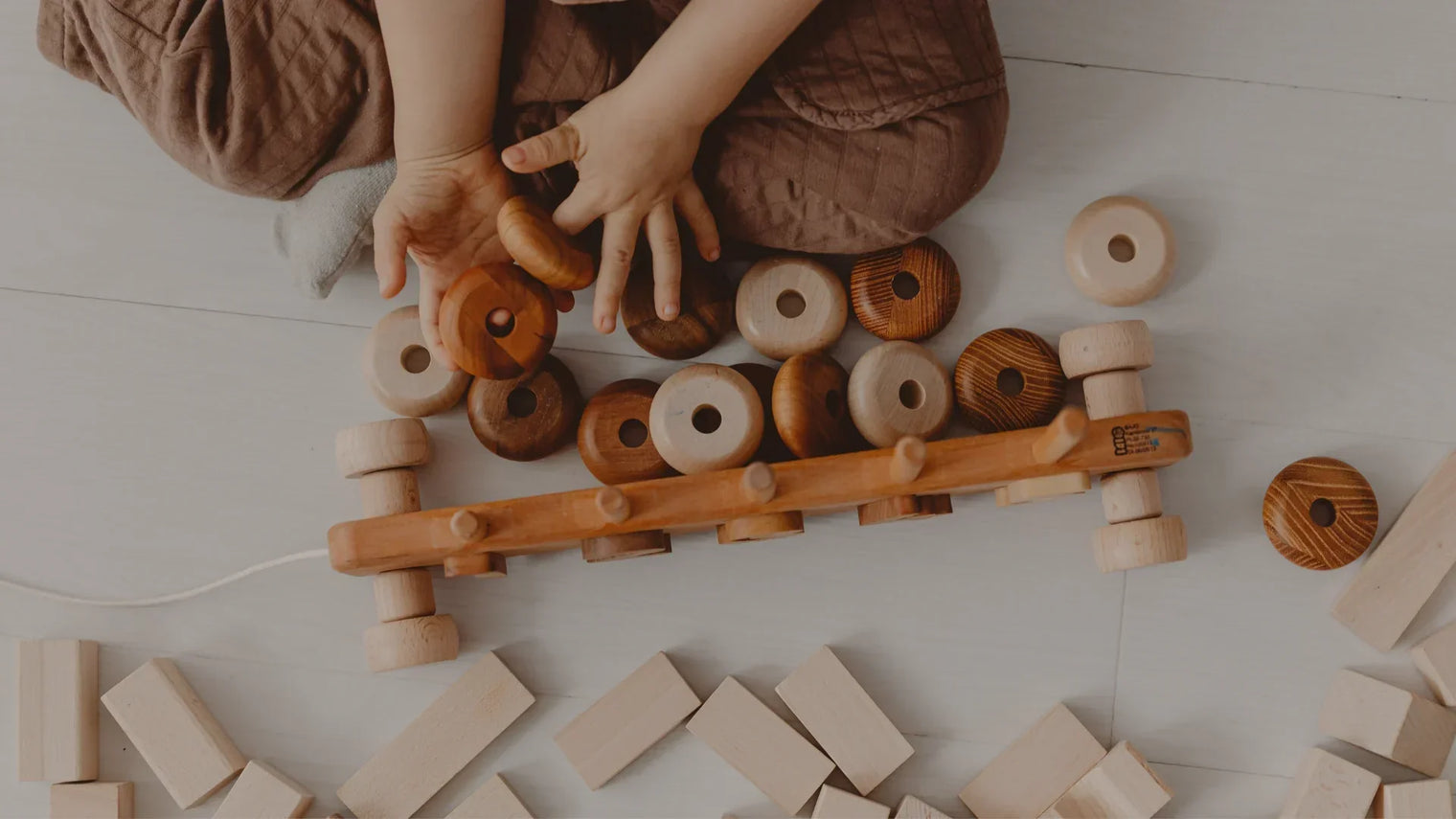 a child playing with Montessori-inspired gifts