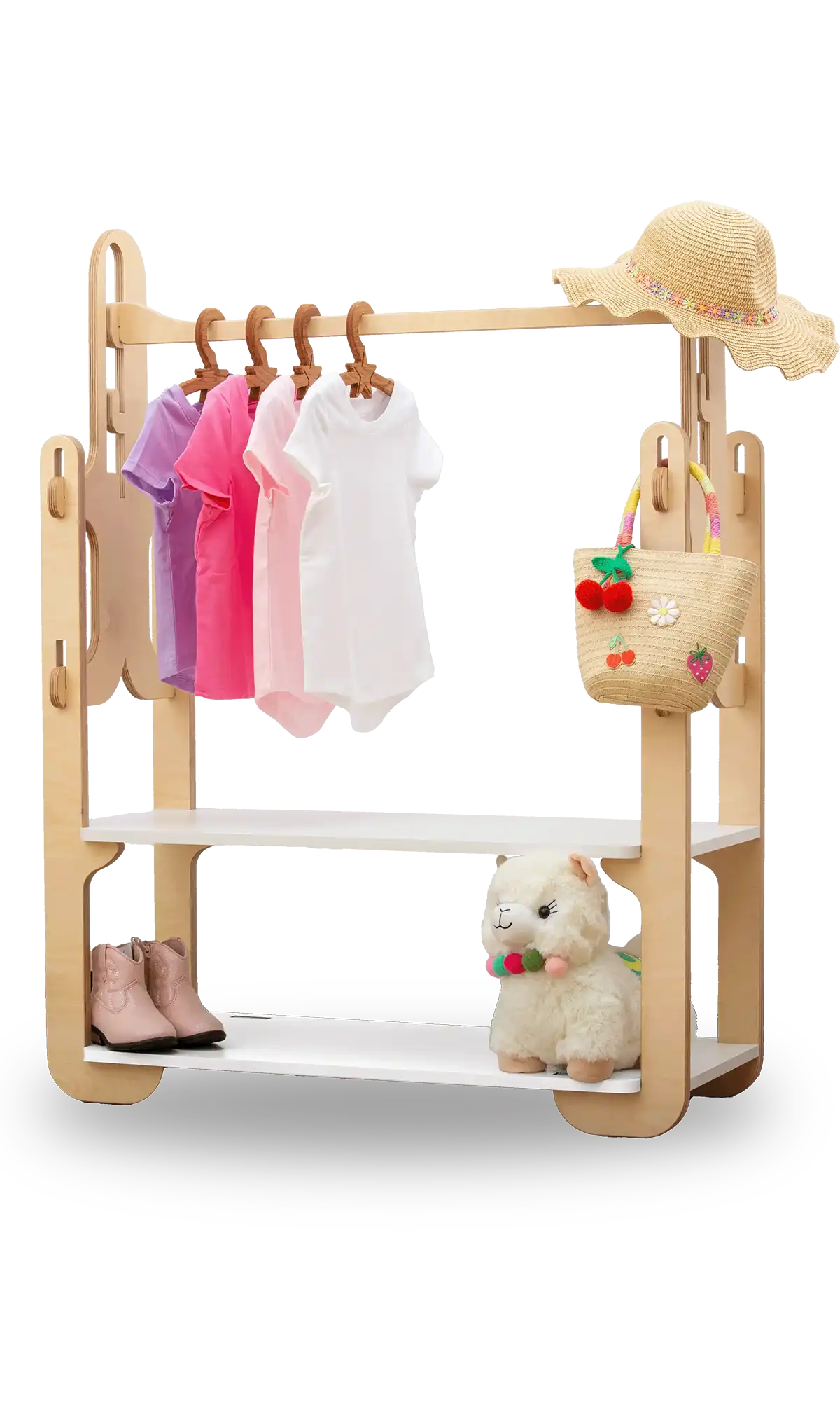 Handcrafted 30-inch wooden clothing rack, featuring a variety of children's clothing and accessories. The rack holds vibrant purple, pink, and white T-shirts on natural wood hangers. A woven straw hat with a multicolored band adorns the top shelf, alongside a playful straw basket embellished with fruit motifs. A pair of chic pink toddler boots and a plush llama toy with a colorful necklace grace the bottom shelf. Perfect for organizing and displaying kids' fashion