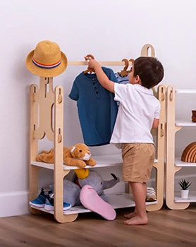 boy picking out his clothes from a montessori wardrobe