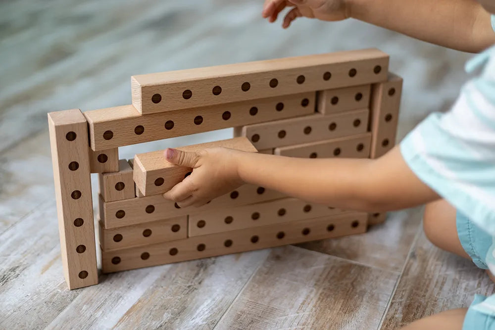 little boy using stackable blocks to learn math