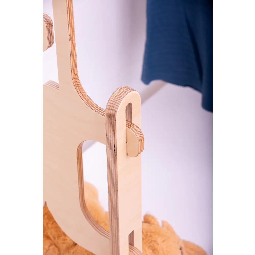 Detail of Dannico Woodworks' expertly crafted layered plywood in a wooden clothing rack, showcasing the precision joinery and smooth finish, ideal for durable and stylish children's room decor.