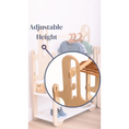 Load image into Gallery viewer, Innovative adjustable-height feature on a custom wooden clothing rack, with a zoomed-in view showcasing the easy-to-use design, perfect for growing children's rooms.
