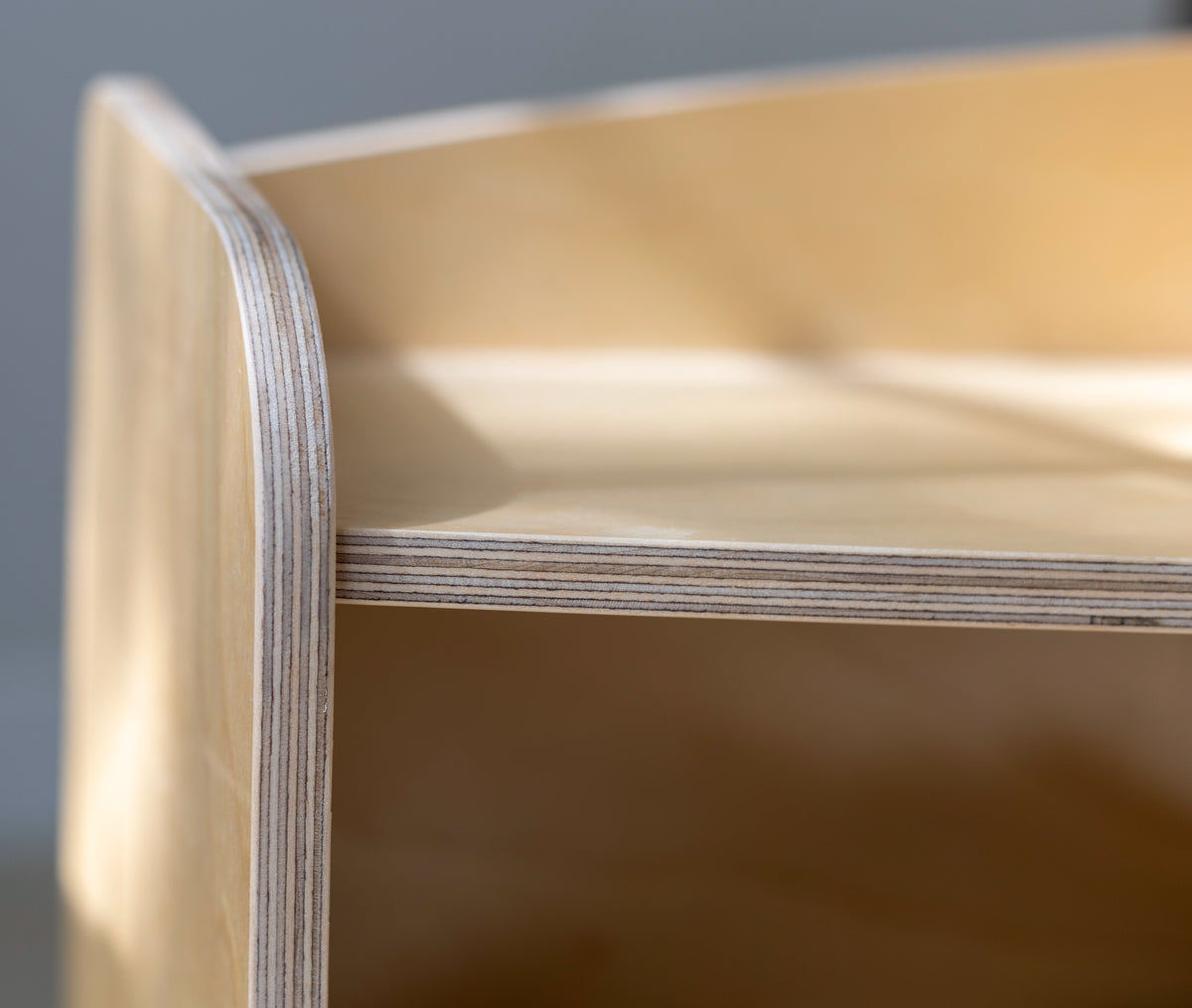Close-up of layered plywood edges on the Montessori toy shelf showing smooth craftsmanship