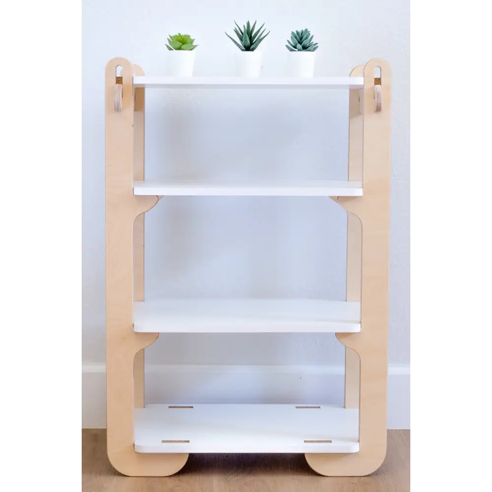 Front view of a four-tier children's wooden shelf with a simple yet stylish design, featuring clean white shelves framed by light natural wood. The top shelf is adorned with three small, neatly potted succulents, bringing a touch of nature into the room. The shelf stands on a wooden floor against a white wall, embodying a modern and minimalist aesthetic that's both functional and appealing in a child-friendly space.