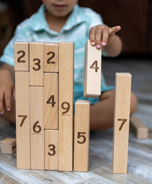 Child playing with number blocks adding up to 9