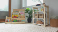 Load and play video in Gallery viewer, showing how our montessori bookshelf works with its hidden storage and top compartment.
